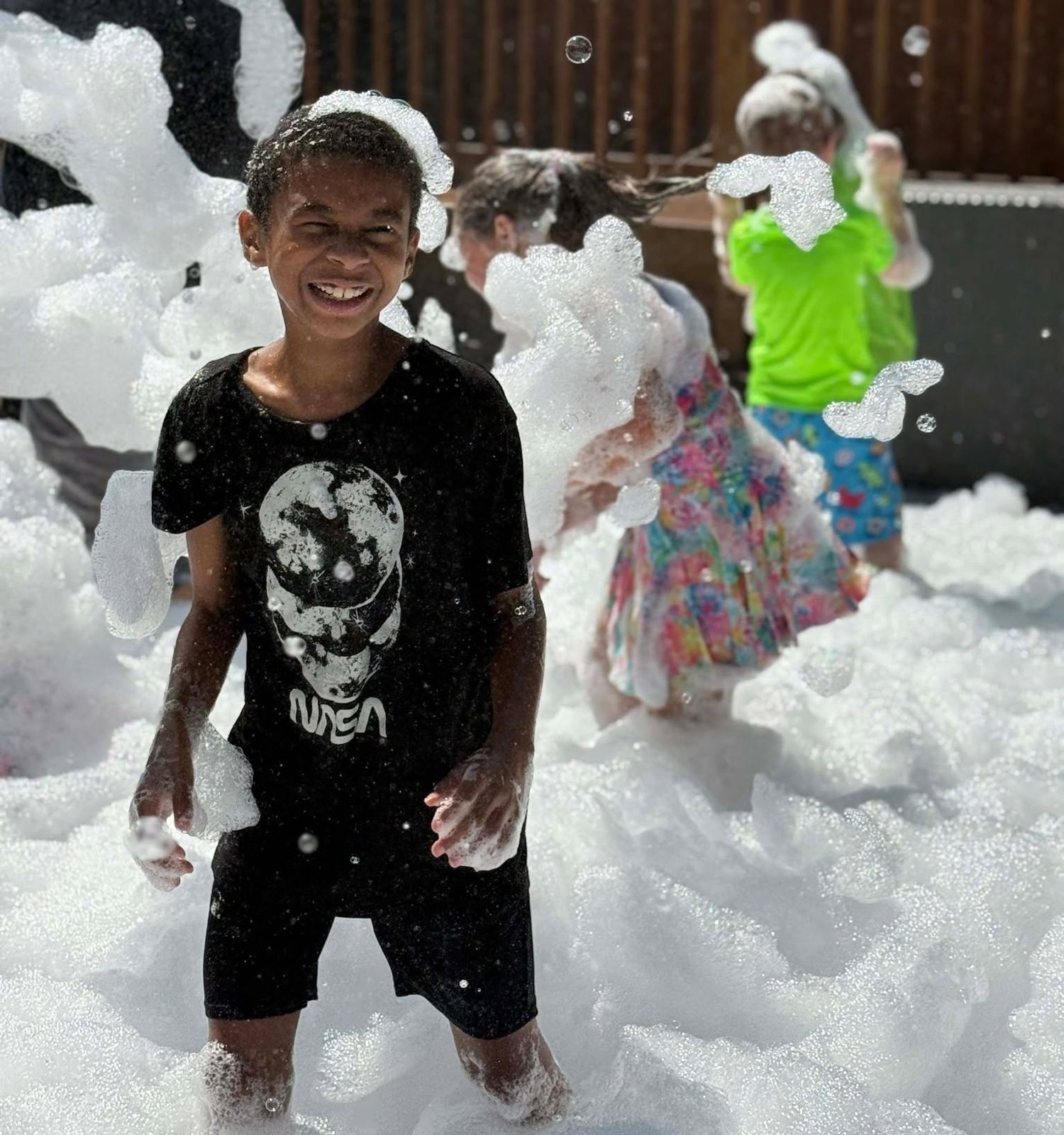 Smiling kid covered in foam