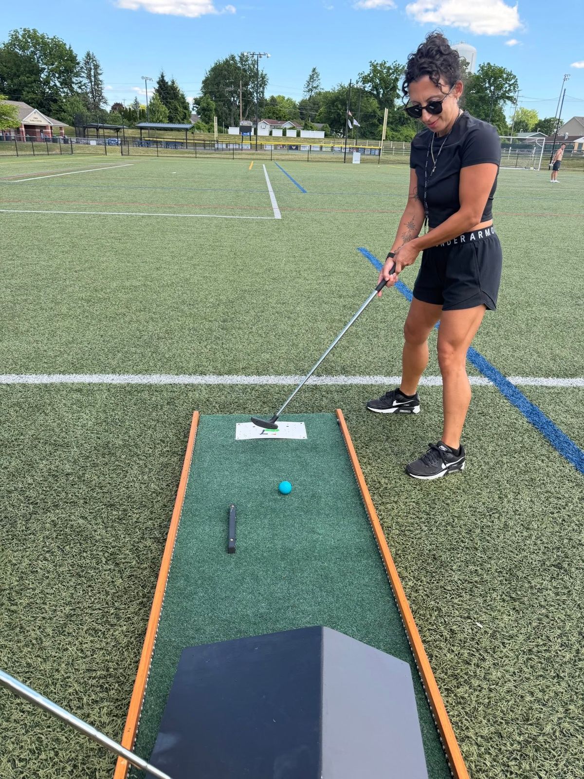 Adult guest putting on our mobile mini golf course